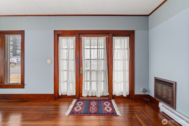 802 May St, Raymond, WA 98577 - entryway featuring a baseboard heating unit, heating unit, wood-type flooring, and ornamental molding