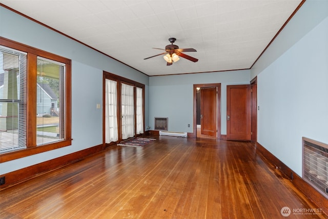 802 May St, Raymond, WA 98577 - empty room with wood-type flooring, ceiling fan, baseboard heating, and heating unit