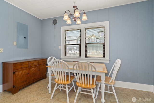 802 May St, Raymond, WA 98577 - dining space with electric panel, ornamental molding, a chandelier, and light floors