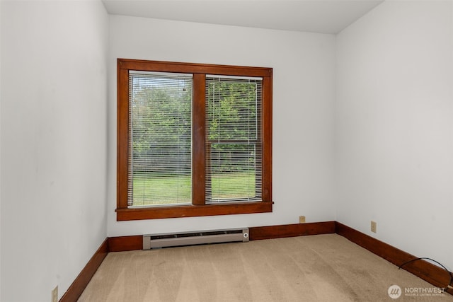 802 May St, Raymond, WA 98577 - carpeted empty room featuring a baseboard heating unit and plenty of natural light