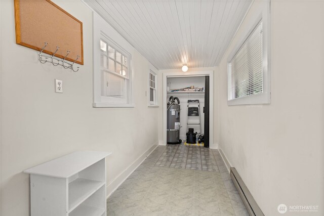 802 May St, Raymond, WA 98577 - hallway with secured water heater, light floors, a baseboard heating unit, and wood ceiling
