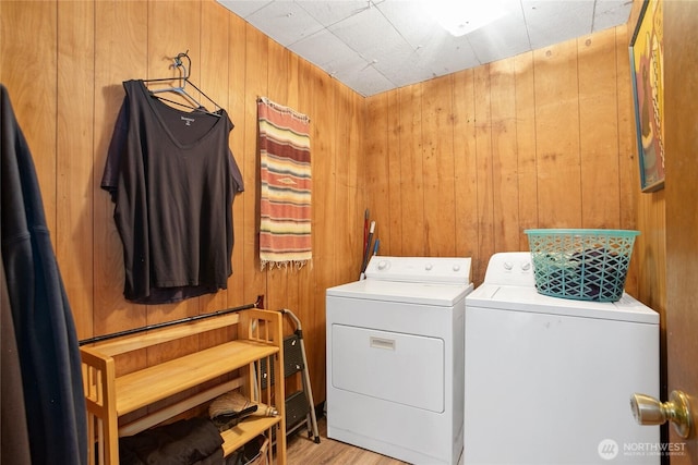 9744 Cascade Loop NE, Olympia, WA 98516 - laundry area with separate washer and dryer, wood walls, and light wood-style flooring