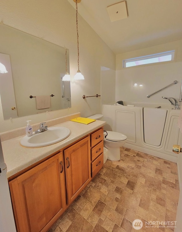5309 NE 75th Ave, Vancouver, WA 98662 - full bathroom with lofted ceiling, vanity, a bath, and stone finish floors
