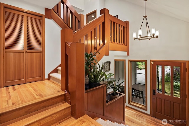 18608 SE 58th St, Issaquah, WA 98027 - entryway with stairway, high vaulted ceiling, light wood-style floors, and a chandelier
