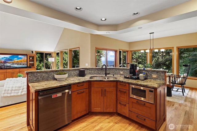 18608 SE 58th St, Issaquah, WA 98027 - kitchen featuring stainless steel appliances, light wood-type flooring, light stone counters, and recessed lighting