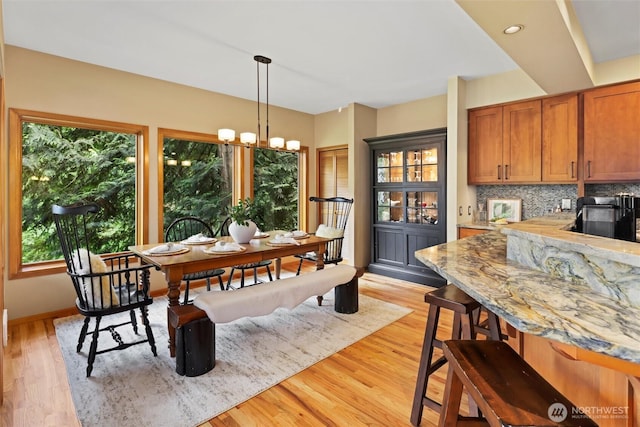 18608 SE 58th St, Issaquah, WA 98027 - dining room with light wood-type flooring and a chandelier