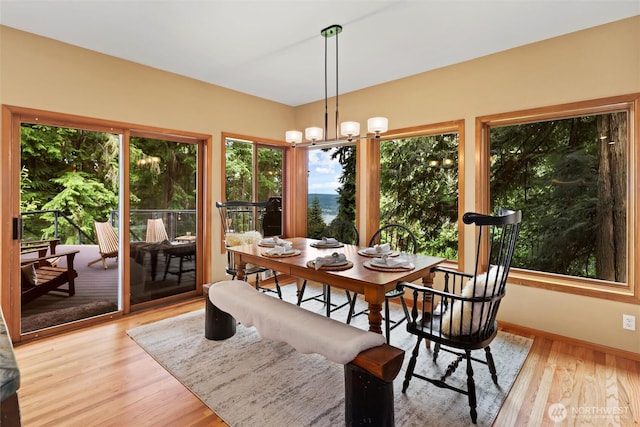 18608 SE 58th St, Issaquah, WA 98027 - dining room with light wood-type flooring and a chandelier
