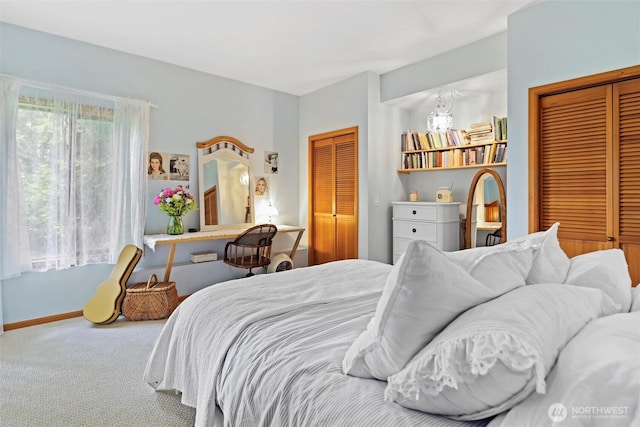 18608 SE 58th St, Issaquah, WA 98027 - bedroom featuring carpet flooring, a chandelier, and two closets