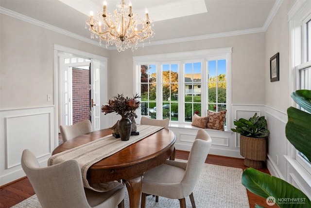 1915 35th Ave W, Seattle, WA 98199 - dining room with crown molding, wood finished floors, a chandelier, a decorative wall, and plenty of natural light