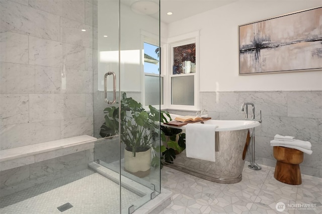 1915 35th Ave W, Seattle, WA 98199 - bathroom featuring tile walls, a stall shower, a soaking tub, tile patterned flooring, and a wainscoted wall