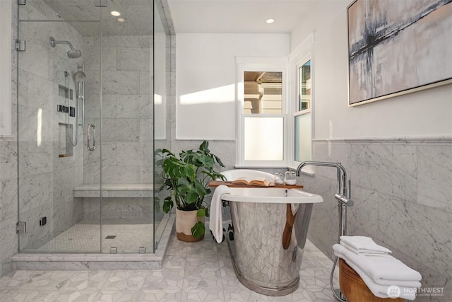 1915 35th Ave W, Seattle, WA 98199 - full bathroom with tile walls, a freestanding bath, a stall shower, recessed lighting, and a wainscoted wall