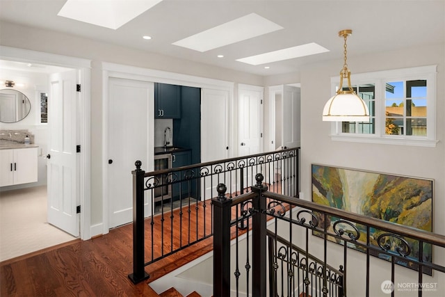 1915 35th Ave W, Seattle, WA 98199 - hallway with a skylight, dark wood finished floors, an upstairs landing, and recessed lighting