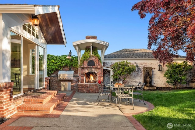 1915 35th Ave W, Seattle, WA 98199 - view of patio / terrace with an outdoor brick fireplace and exterior kitchen
