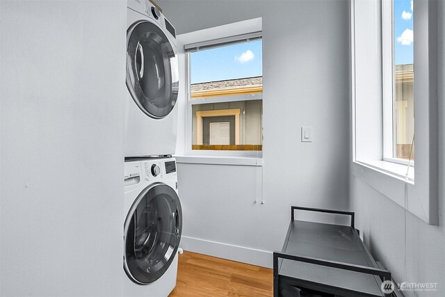 807 24th St, Anacortes, WA 98221 - washroom featuring estacked washer and dryer, light wood-type flooring, and plenty of natural light