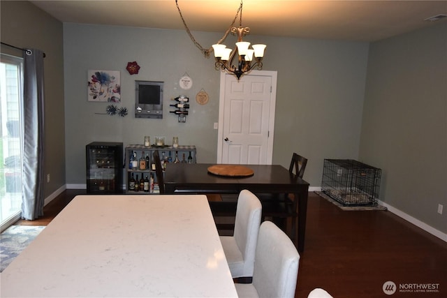 4201 Mckinley St NE, Lacey, WA 98516 - dining room featuring beverage cooler, a chandelier, wood finished floors, and healthy amount of natural light