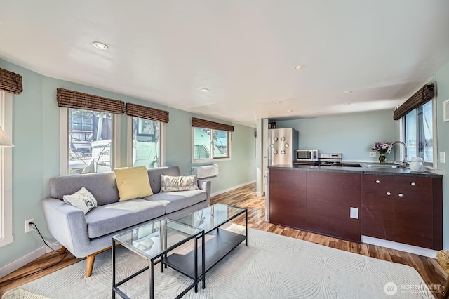 1818 Westlake Ave N Unit D-33, Seattle, WA 98109 - living area featuring healthy amount of natural light, light wood-style floors, recessed lighting, and a wall unit AC