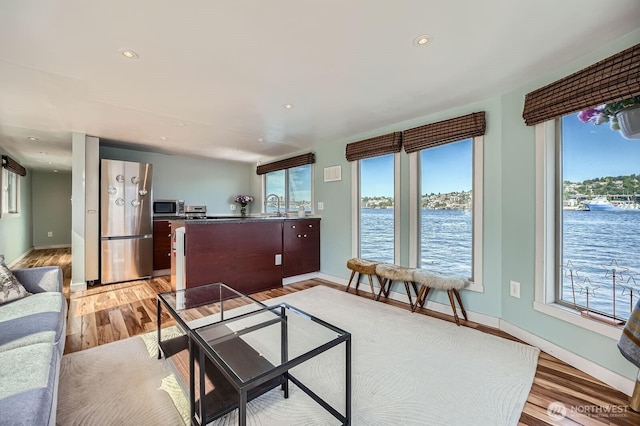 1818 Westlake Ave N Unit D-33, Seattle, WA 98109 - living area featuring plenty of natural light, light wood-style flooring, a water view, and recessed lighting
