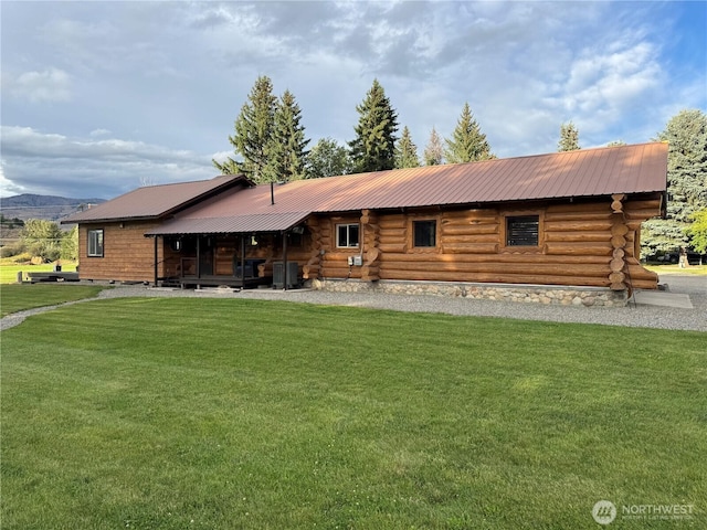8 Iris Ln, Twisp, WA 98856 - back of house featuring a lawn, log exterior, and a metal roof
