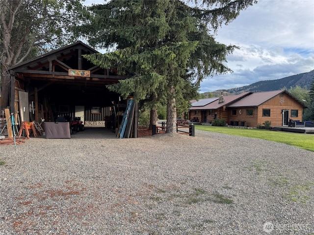 8 Iris Ln, Twisp, WA 98856 - view of front of home featuring a carport, driveway, a metal roof, a mountain view, and log siding