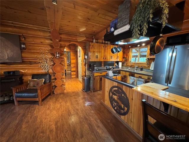8 Iris Ln, Twisp, WA 98856 - kitchen with log walls, wood finished floors, arched walkways, wooden ceiling, and butcher block counters
