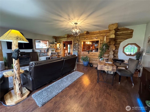 8 Iris Ln, Twisp, WA 98856 - living area featuring log walls, wood finished floors, a fireplace, and healthy amount of natural light