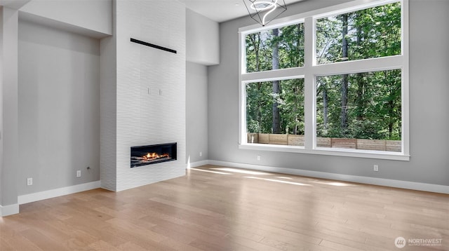 1542 213th Ct NE, Sammamish, WA 98074 - unfurnished living room featuring wood finished floors and a fireplace