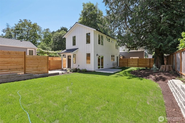 11737 38th Ave NE Unit B, Seattle, WA 98125 - rear view of house with board and batten siding and a fenced backyard
