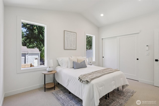 11737 38th Ave NE Unit B, Seattle, WA 98125 - carpeted bedroom featuring multiple windows, vaulted ceiling, a closet, and recessed lighting