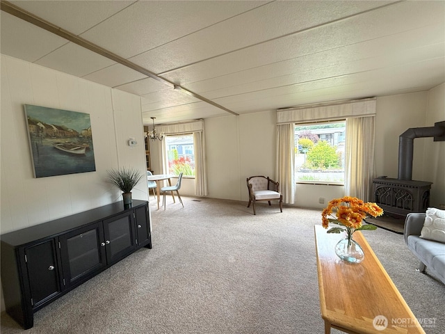 1200 Lincoln St Unit 418, Bellingham, WA 98229 - living area with a wood stove, carpet floors, and a chandelier