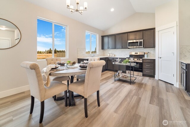 5763 S Sherri Lea Rd, Spokane, WA 99224 - dining area with a chandelier, light wood-type flooring, and high vaulted ceiling
