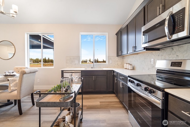5763 S Sherri Lea Rd, Spokane, WA 99224 - kitchen with appliances with stainless steel finishes, light wood finished floors, and light countertops