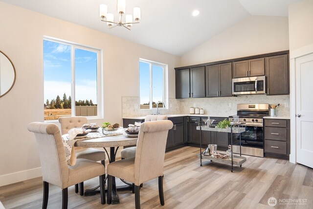 5763 S Sherri Lea Rd, Spokane, WA 99224 - dining room with a chandelier, light wood-style flooring, and high vaulted ceiling