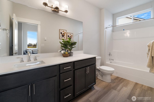 5819 S Sherri Lea Rd, Spokane, WA 99224 - full bath with wood finished floors, vanity, and shower / washtub combination