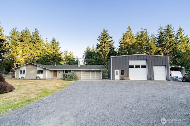 636 Nevil Rd, Winlock, WA 98596 - view of front of property featuring board and batten siding, a detached garage, and an outdoor structure