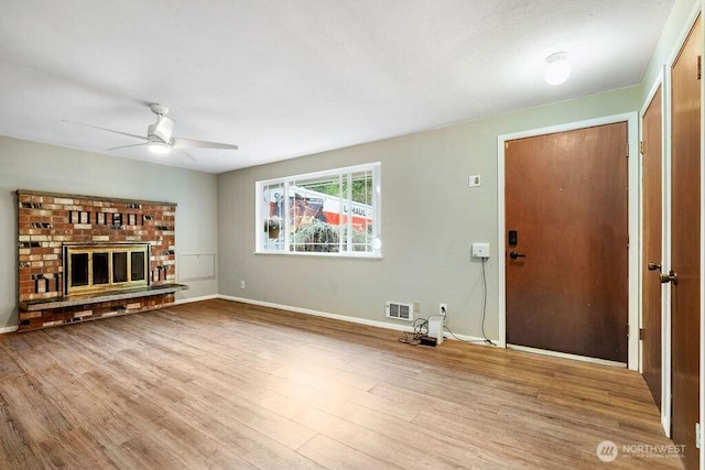 636 Nevil Rd, Winlock, WA 98596 - unfurnished living room with a ceiling fan, wood finished floors, and a brick fireplace