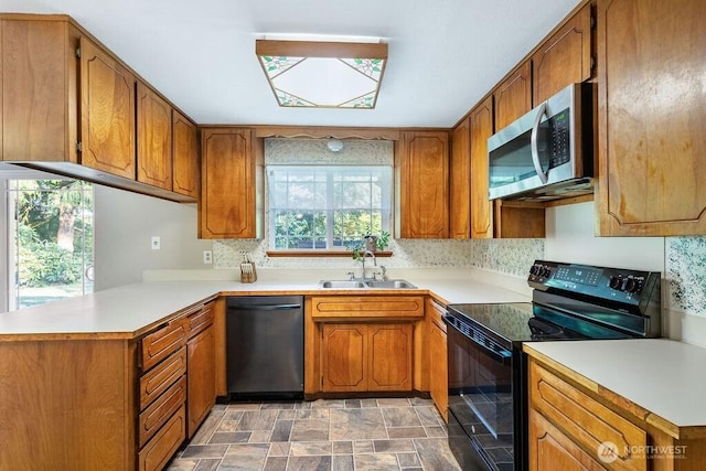 636 Nevil Rd, Winlock, WA 98596 - kitchen featuring black range with electric stovetop, stainless steel microwave, dishwashing machine, and brown cabinetry