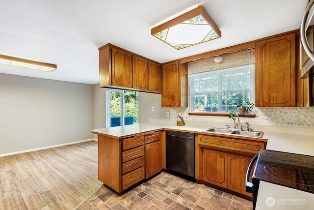 636 Nevil Rd, Winlock, WA 98596 - kitchen featuring dishwasher, brown cabinets, and a peninsula