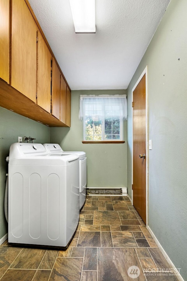 636 Nevil Rd, Winlock, WA 98596 - laundry room featuring washer and clothes dryer, cabinet space, dark stone finish floors, and a textured ceiling