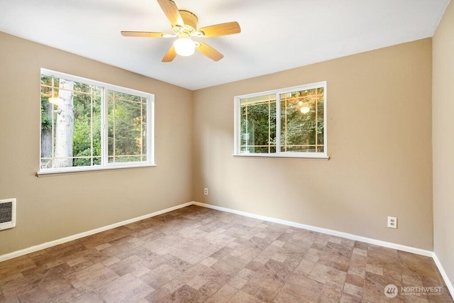 636 Nevil Rd, Winlock, WA 98596 - empty room featuring a ceiling fan and stone finish floors