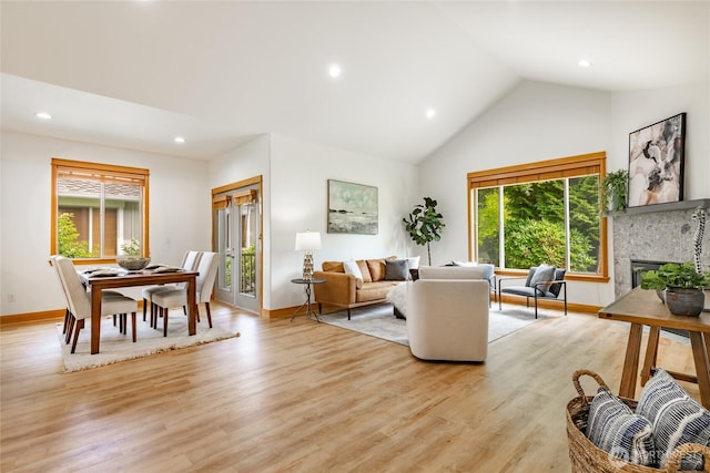 9002 Gleneagle Dr, Blaine, WA 98230 - living room with recessed lighting, a glass covered fireplace, light wood-style flooring, and high vaulted ceiling