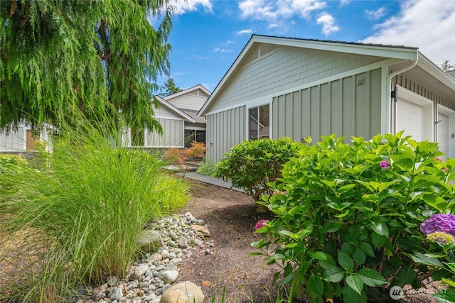 9002 Gleneagle Dr, Blaine, WA 98230 - view of side of property with board and batten siding and a garage
