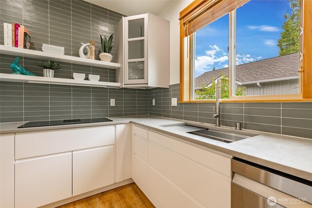 9002 Gleneagle Dr, Blaine, WA 98230 - kitchen featuring stainless steel dishwasher, open shelves, backsplash, black electric stovetop, and light countertops