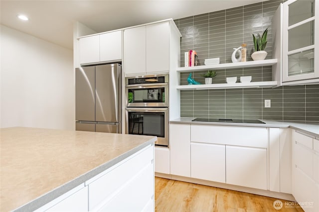 9002 Gleneagle Dr, Blaine, WA 98230 - kitchen with appliances with stainless steel finishes, tasteful backsplash, light wood-type flooring, light countertops, and recessed lighting