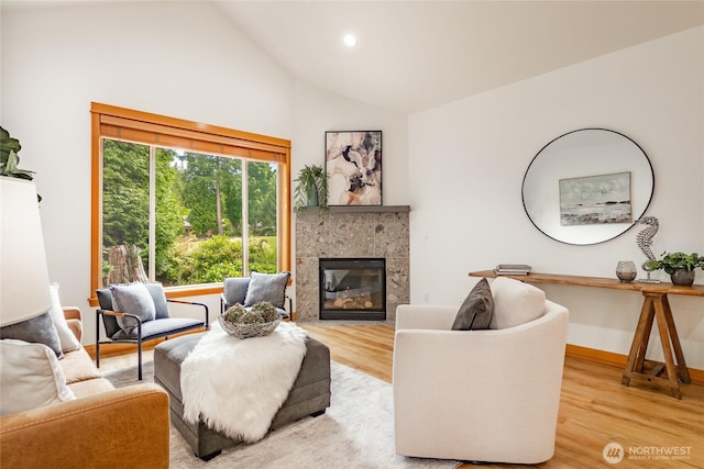 9002 Gleneagle Dr, Blaine, WA 98230 - living room featuring light wood-style floors, a tile fireplace, high vaulted ceiling, and recessed lighting
