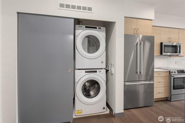 11903 NE 128th St Unit 205, Kirkland, WA 98034 - laundry room featuring stacked washing machine and dryer and dark wood-style flooring