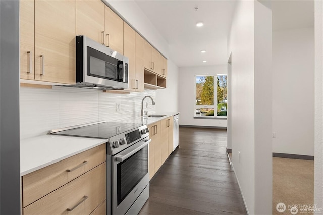 11903 NE 128th St Unit 205, Kirkland, WA 98034 - kitchen with stainless steel appliances, light brown cabinetry, tasteful backsplash, light countertops, and recessed lighting
