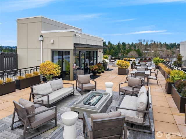 11903 NE 128th St Unit 205, Kirkland, WA 98034 - view of patio with an outdoor living space with a fire pit