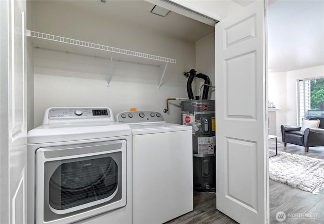5000 Lake Washington Blvd NE Unit B201, Renton, WA 98056 - laundry room with electric water heater, wood finished floors, and independent washer and dryer