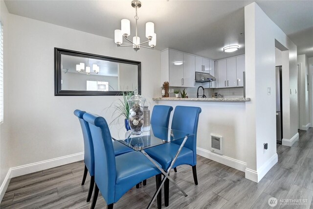 5000 Lake Washington Blvd NE Unit B201, Renton, WA 98056 - dining room featuring a chandelier and light wood finished floors