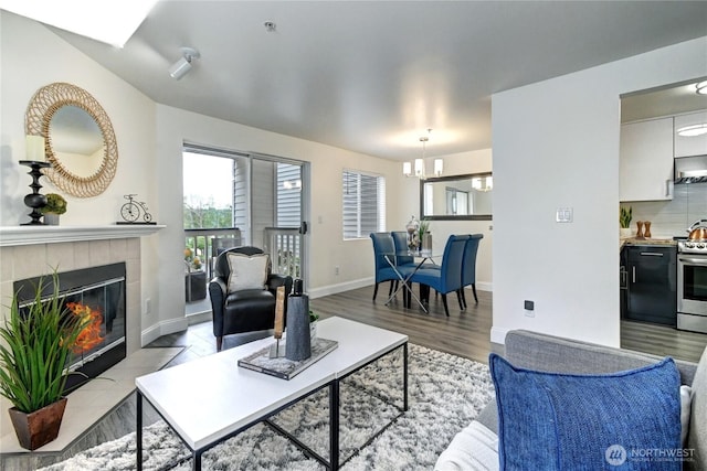5000 Lake Washington Blvd NE Unit B201, Renton, WA 98056 - living room featuring a chandelier, wood finished floors, and a tile fireplace